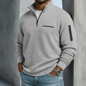 Vue détaillée du polo pour homme gris à texture quadrillée avec poche zippée sur le bras