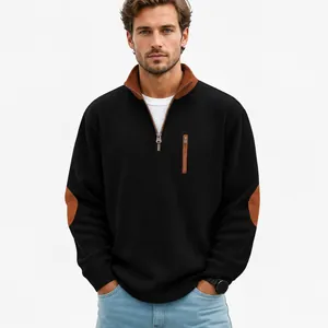 Detail view of men's black corduroy half-zip sweatshirt with brown elbow patches