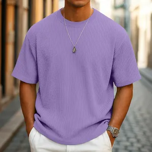 Detailed view of a men's lavender waffle knit t-shirt featuring a relaxed fit on a model.