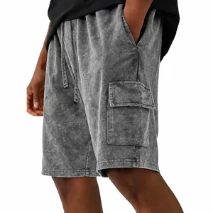 Detailed macro view of men's vintage washed cargo shorts featuring a large side flap pocket