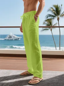 Detailed view of breathable lime green linen trousers with adjustable drawstring waist