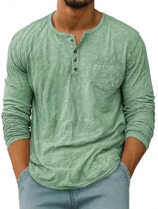 Close-up detail of men's green long sleeve Henley shirt with chest pocket and textured fabric