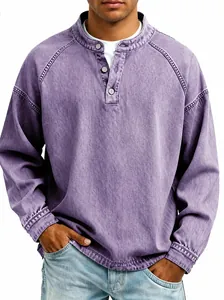 Detail of vintage washed purple Henley shirt showing distressed texture and button placket
