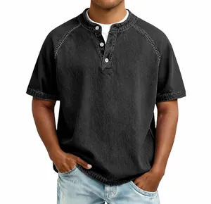Close-up detail of men's vintage distressed cotton Henley shirt in washed black finish