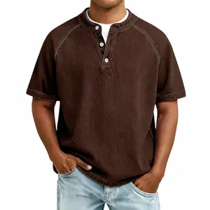 Detailed view of a men's brown vintage washed cotton Henley shirt with raglan sleeves.