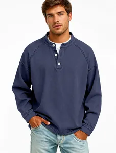 Professional close-up of men's vintage faded blue Henley long sleeve shirt with buttons