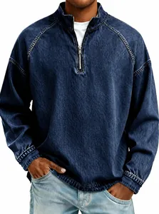Close-up of men's vintage washed denim quarter-zip pullover with metal zipper detail.