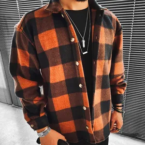 Detail view of men's casual orange and black checkered long-sleeve shirt texture