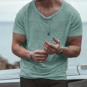 Close-up of men's slub cotton short sleeve T-shirt in sage green with textured finish