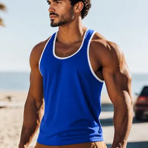 Close-up of blue athletic tank top with white contrast piping on a fit male model