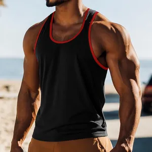 Close-up of black men's tank top with red trim on muscular athletic model outdoors