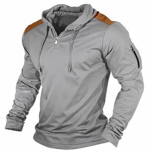 Close-up detail of men's grey hoodie with brown shoulder patches and a sleeve zipper pocket