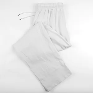 Close-up of white breathable linen wide-leg trousers for men with elastic drawstring waist