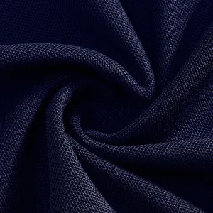 Macro detail of navy blue quick-dry breathable piqué fabric texture for polo shirt