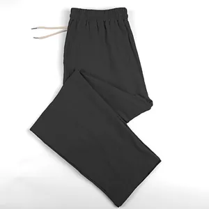 Detailed view of men's breathable grey linen wide-leg pants with drawstring waist
