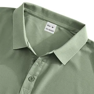 Macro view of men's green breathable polo shirt collar showing size M polyester tag