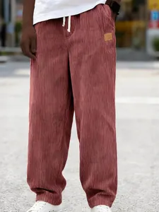 Men's loose corduroy drawstring trousers in brick red, stylish outdoor street wear
