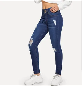 Detailed side view of high-waisted distressed skinny jeans in dark blue denim