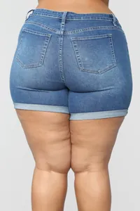 Rear detail view of women's plus size stretchy blue denim shorts with folded hem