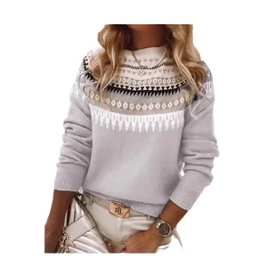 Dettaglio maglione grigio a lupetto con eleganti motivi geometrici in maglia jacquard.