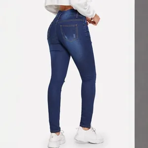 Women's stretchy dark blue ripped skinny jeans with a high waist and slim fit denim design
