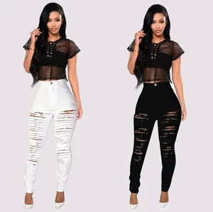 Detail view of high waisted ripped skinny stretch jeans in black and white colors