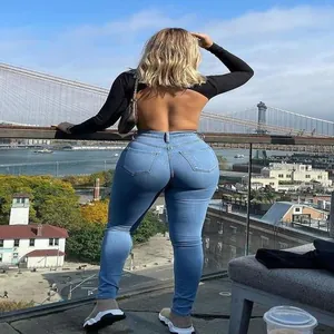Slim fit high-waisted blue denim jeans showing flattering back view and stretch material