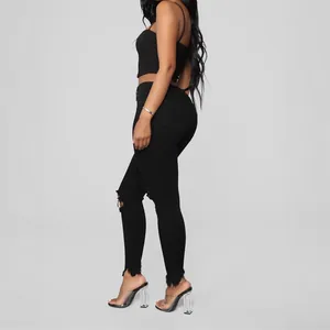 Vaqueros pitillo negros para mujer con rodillas rotas y dobladillo deshilachado elegante