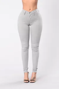 Detailed view of women's high-waisted stretchy skinny jeans in light grey