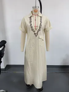 Casual beige cotton linen maxi dress featuring intricate leaf embroidery on V-neck lapel