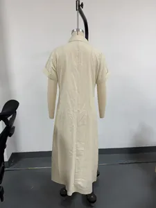 Back view of a beige loose cotton linen dress with short sleeves on a mannequin.
