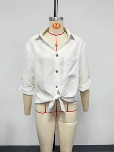 Close-up of a white linen-style short sleeve shirt with front tie-knot and V-neck detail.