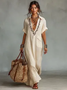 Detailed full-length view of loose cotton linen maxi dress featuring embroidered V-neckline