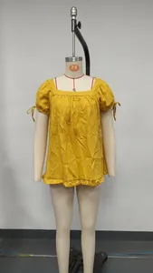 Yellow square neck short sleeve shirt with ruffle hem and tie-knot sleeves on mannequin