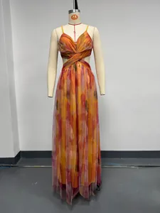 Elegant sleeveless mesh maxi dress with abstract orange print displayed on a mannequin.