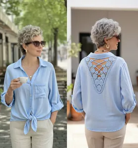 Front and back view of a light blue button-down shirt with crochet lace back detail.