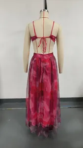 Back view of a mesh floral print maxi dress with spaghetti straps and open back tie