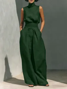 Chic dark green sleeveless high-neck linen top paired with elegant wide-leg trousers