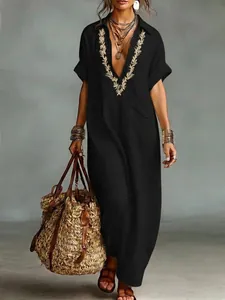 Detailed view of women's black cotton linen maxi dress with wheat embroidery and lapel