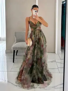 Elegant floral print mesh maxi dress with spaghetti straps and cutout waist detail