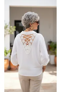 Detailed view of white blouse with hollow lace V-back and crisscross strap design