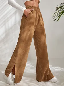 Close-up view of brown corduroy wide-leg trousers featuring a stylish split hem design