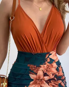 Detail of a sexy orange cami top and floral print patchwork bodycon dress showing fabric texture