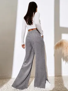 Detailed back view of grey corduroy wide-leg trousers with side split hem