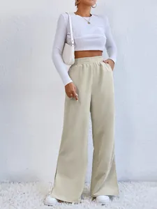 Detailed view of high-waisted beige corduroy casual pants with stylish slit hem design