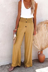 Full length view of mustard yellow cotton linen wide leg trousers on a female model