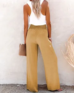 Back view of women's mustard yellow wide-leg linen trousers with elastic high waist.