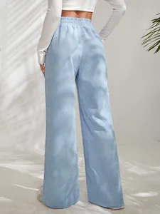 Detailed back view of women's light blue high-waisted corduroy wide-leg pants with split hem