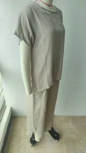 Women's casual loose two-piece set featuring short sleeve top and wide-leg pants on mannequin.