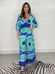 Full length detail view of women's plus size tie-dye print jumpsuit with flared sleeves